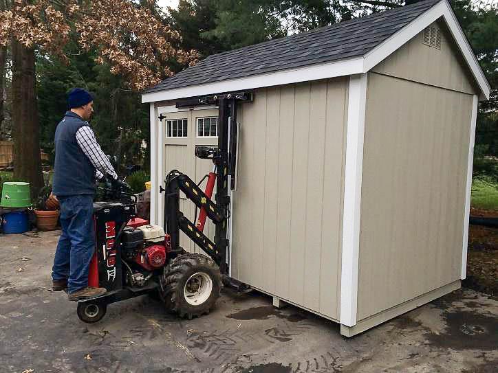 man moves shed with mule