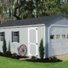 A-Frame shed with gray siding and overhead door