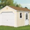 A-Frame shed with tan siding, white trim and overhead door
