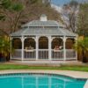 12' x 16' oval white vinyl gazebo with pagoda roof, screens and cupola