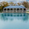 20' x 40' rectangle country style white vinyl gazebo with 5" x 5" posts, gallery blue standing seam and screens