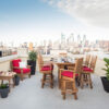 A table and chair on top of a building overlooking a city