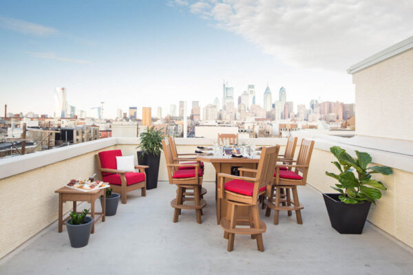 A table and chair on top of a building overlooking a city