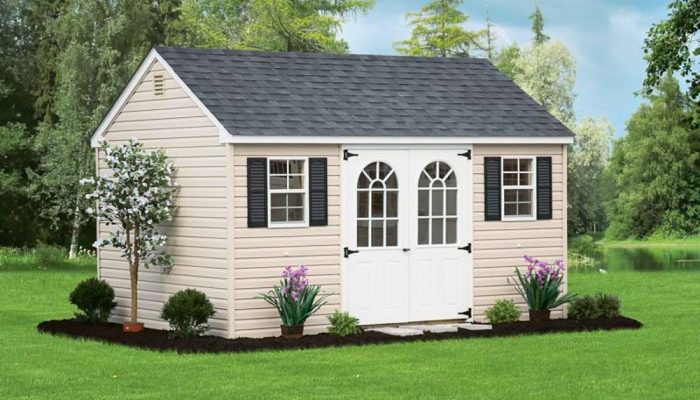 Tan Cape Cod Shed with white double doors and dark shingle roof