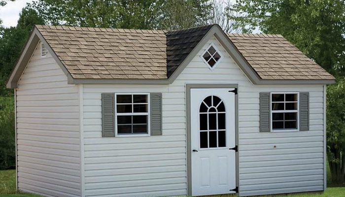 Tan Cape Cod Shed with reverse gable over door